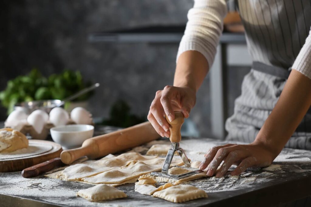 A cooking class in Italy. The client is making ravioli. 