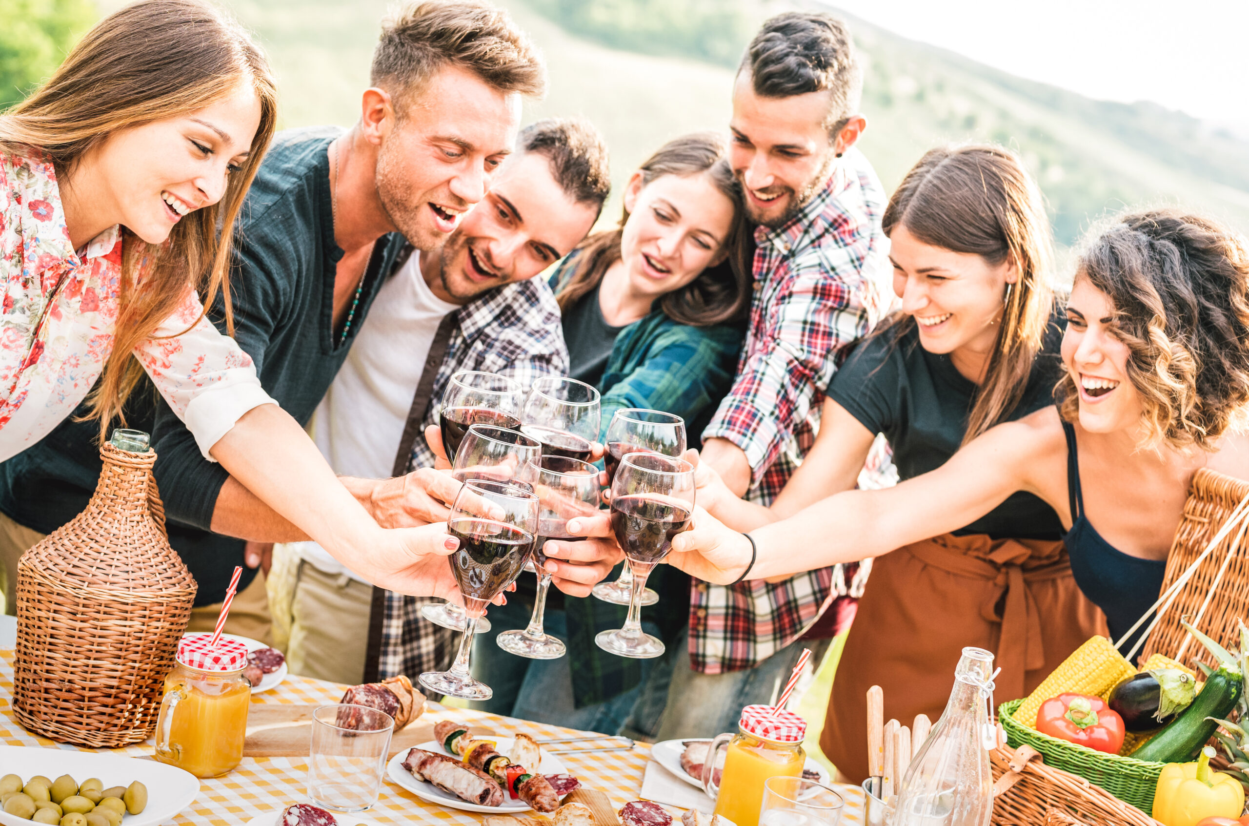 Group enjoying a vineyard-style picnic with wine and local food — capturing the joy of a thoughtfully planned travel experience.